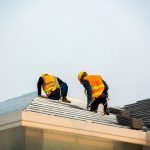 two roofing contractors on roof