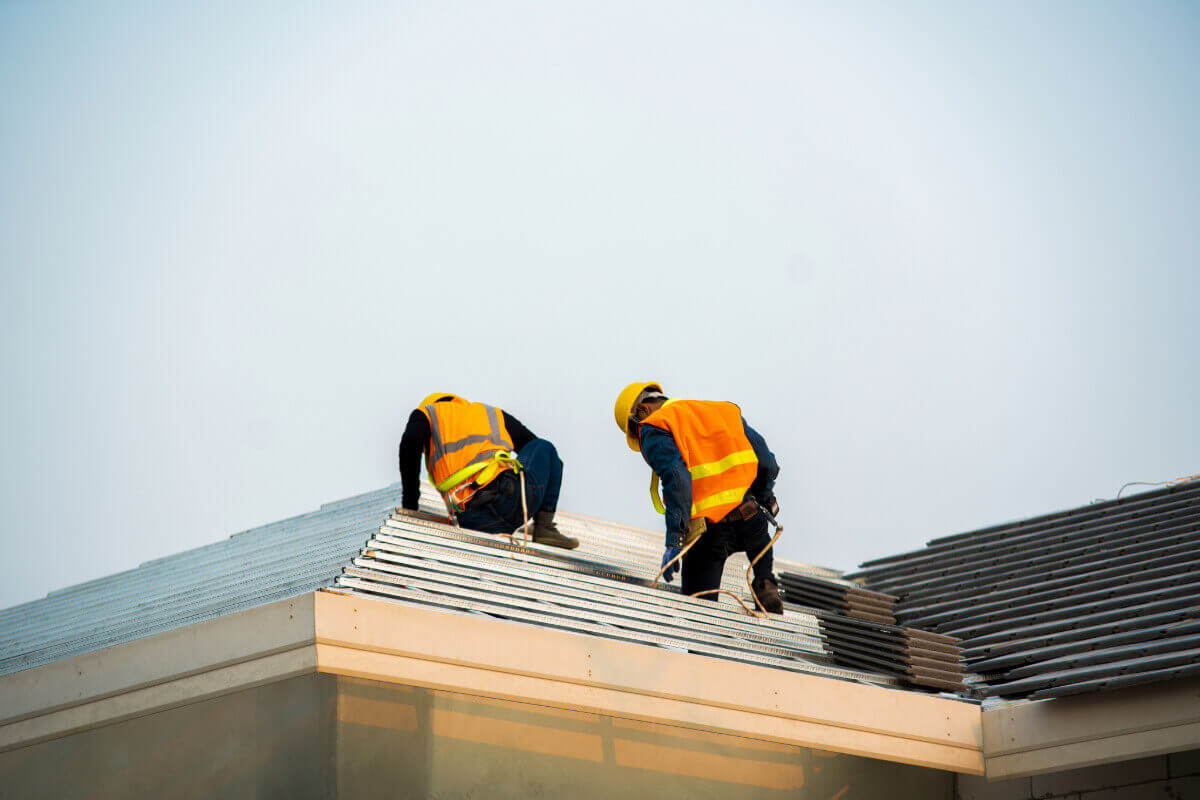 two roofing contractors on roof